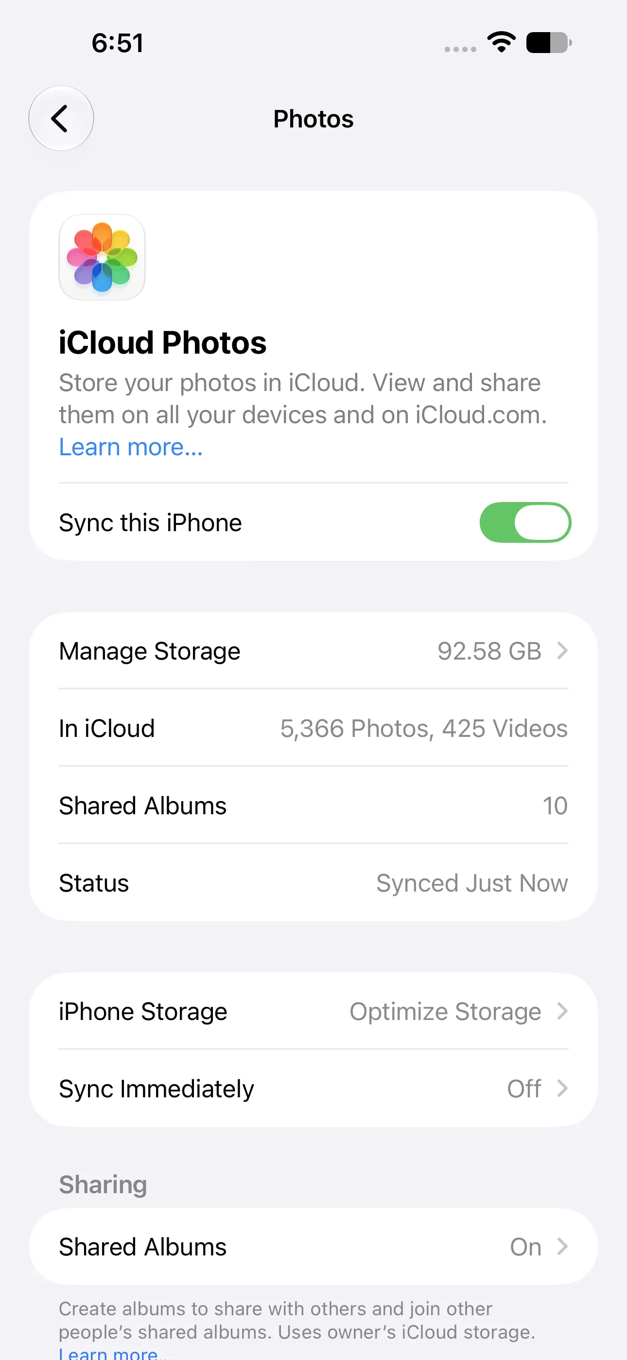 The iCloud Photos settings screen showing Sync this iPhone and Optimize Storage.